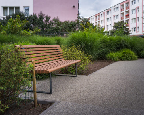 Ławka na skwerze wśród zieleni